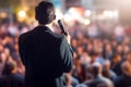 Spectacular male politician speaks on stage in front of crowds