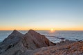 Spectacular morning mountain panorama with sun raising above sea of clouds. Royalty Free Stock Photo