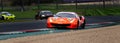 Spectacular motorsport scenic view of supercar touring Ferrari 488 racing car in action out of curve on kerbs Royalty Free Stock Photo