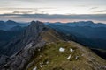 Spectacular mountain view of sun rising above high ridge in the distance.