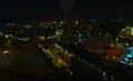 Spectacular night panorama the Remontova shipyard with submarine in to dry dock. Poland, Gdansk, drone footage,