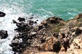 Spectacular outdoor view of a rocky cliff face with stairs leading down to the edge of a serene lake Royalty Free Stock Photo