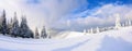 Spectacular panorama is opened on mountains, trees covered with white snow, lawn and blue sky with clouds. Royalty Free Stock Photo