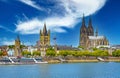 Spectacular riverfront skyline. three churches, dome, rhine cruis ship, clear blue summer sky, white cloud, TV tower Royalty Free Stock Photo