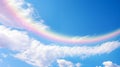 A beautiful rainbow in the sky with white clouds and blue sky in the background