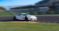 Spectacular scenic racing car on asphalt racetrack Porsche 911 blurred motion background