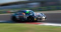 Spectacular scenic racing car on asphalt racetrack Porsche 911 blurred motion background