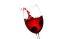 Spectacular splash and flying drops of red wine in an elegant glass Royalty Free Stock Photo