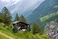 Spectacular summer alpine landscape, mountain swiss wooden chalet with high mountains in background, Zermatt Royalty Free Stock Photo