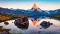 Spectacular summer sunrise on Stellisee lake. First sunlight glowing peak of Matterhorn summit in Swiss Alps, Switzerland, Europe.