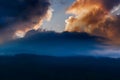 Spectacular sun set with colourful clouds in the sky beyond mountain peaks. Shot at Okhrey, Sikkim, India