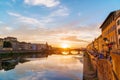 Sunset over Arno river in Florence, Italy. Spectacular sky, medieval bridge and buildings. Royalty Free Stock Photo