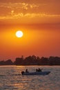 Boat with tourists at a summer sunset in the Danube Delta, Romania Royalty Free Stock Photo
