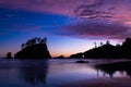 Spectacular sunset over sea silhouettes rock formations and trees Royalty Free Stock Photo