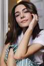 Spectacular tanned woman in pajamas posing in her apartment. Indoor photo of relaxed brunette girl Royalty Free Stock Photo