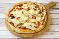 Spectacular vegetarian pizza recipe with thin crust, mushrooms, peppers and zucchini on unvarnished wooden board