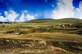 Landscape panorama summer scenery of green hills and white clouds Royalty Free Stock Photo