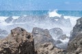 Spectacular view over lava rocks with breaking of waves