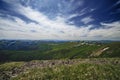 Spectacular view from the top of the mountain to the mountain slopes and meadows Royalty Free Stock Photo