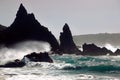 Spectacular view of waves crashing on the silhouette of rock pillars at sea