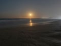 Spectacular views of the sea at sunset and the moon reflecting on the beach of Gandia. Spain. Royalty Free Stock Photo
