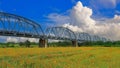 The spectacular Warren Truss Old Railway Bridge over scenic flower field Royalty Free Stock Photo