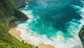 Spectacular waves rampage in the Manta Bay or Kelingking Beach with blue crystal water, Nusa Penida Island, Bali