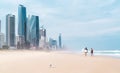 Spectacular wide panorama of the Gold Coast skyline and the rolling waves of the Pacific Ocean at Surfers Paradise beach. Royalty Free Stock Photo