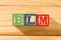 Spectacular wooden cubes with the word BLM BLACK LIVES MATTER on a wooden surface