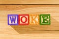 Spectacular wooden cubes with the word WOKE on a wooden surface Royalty Free Stock Photo