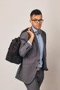 A spectacular young businessman in suit with big bag