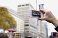 A spectator makes a video recording of the Toronto Santa Claus Parade - 2013