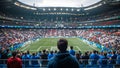 Spectator watching football match in crowded stadium Royalty Free Stock Photo