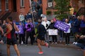 Spectators cheering on NYC Marathon runners. Running race and fans with posters and signs