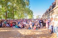 Spectators at a lecture on the open area of the beach.