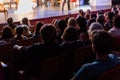 Spectators at a theater performance, in a cinema or at a concert. Shooting from behind. The audience in the hall