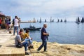 Spectators watching and photographing the Rolex Middle Sea Yacht Rac