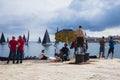 Spectators watching and photographing the Rolex Middle Sea Yacht Race Royalty Free Stock Photo