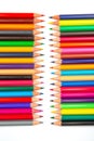 A spectrum of sharpened colored pencils layered in a grid on a white background. Suitable for artistic tools, school essentials, Royalty Free Stock Photo