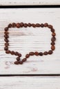 Speech bubble made from coffee beans.