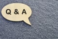 Speech bubble with Q and A on concrete background.