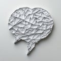 Geometric origami speech bubble with sharp white paper folds on a white surface. Royalty Free Stock Photo
