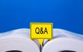 Speech bubble written with Q&A on an open book Royalty Free Stock Photo