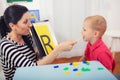 Speech therapist teaches the boys to say the letter R Royalty Free Stock Photo