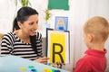 Speech therapist teaches the boys to say the letter R Royalty Free Stock Photo