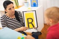 Speech therapist teaches the boys to say the letter R Royalty Free Stock Photo