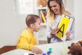 Speech therapist teaches the boys to say the letter A Royalty Free Stock Photo