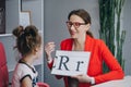 Speech therapist teaches the girls to say the letter R. Female Speech Language Therapist Teaching Preschool Kid Sound