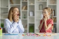 Speech Therapist Woman Making Articulation Exercises With Little Girl At Therapy Session