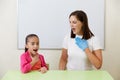 Speech therapist working with girl training pronunciation Royalty Free Stock Photo